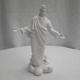 White religious statue of Jesus with outstretched arms