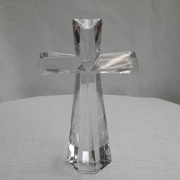 Clear glass cross figurine on a light surface