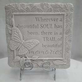 Decorative plaque with a butterfly and memorial quote on a stand