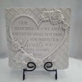Decorative memorial plaque with raised flowers and a heart-shaped quote