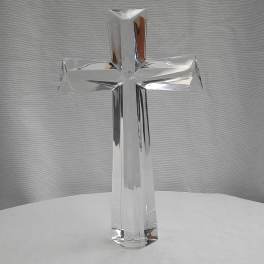 Clear glass cross ornament on a white surface