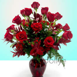 Red roses arranged in a dark glass vase