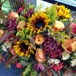 Mixed bouquet with sunflowers, roses, and chrysanthemums in warm autumn colors