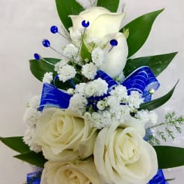 White rose bouquet with blue ribbon and small white filler flowers