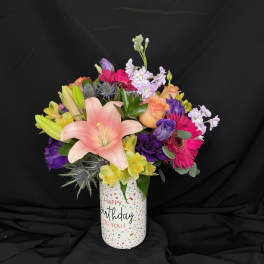 Mixed bouquet in a birthday vase with pink lily and bright gerberas