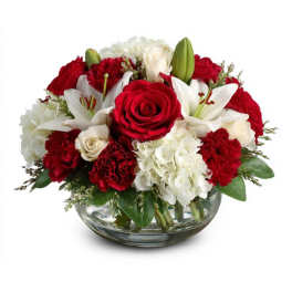 Red roses and white lilies arranged in a glass bowl vase