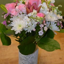 Pink and white mixed bouquet in a glass vase wrapped with lace