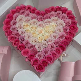 Heart-shaped box filled with pink and white roses