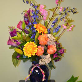 Colorful mixed bouquet in a dark blue vase