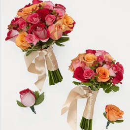Two rose bouquets and two rose boutonnieres with cream ribbons