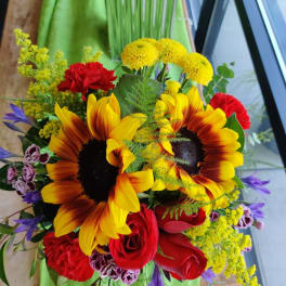 Bouquet of sunflowers, red roses, and mixed accent flowers