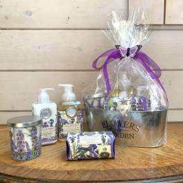 Lavender-themed gift basket with soaps, lotion, and a candle