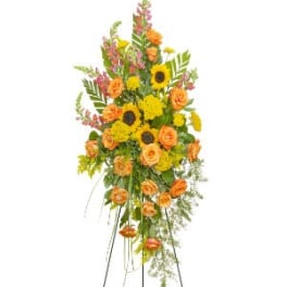 Tall floral standing spray with orange roses and yellow sunflowers