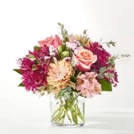 Pink and peach mixed bouquet in a clear glass vase
