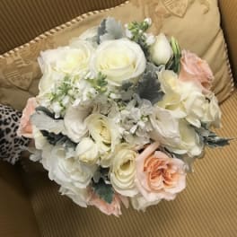 Bouquet of white and blush roses with pale filler flowers