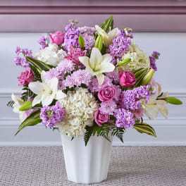 Pink and white mixed flower arrangement in a white vase