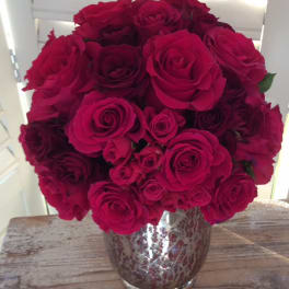 Bouquet of deep pink roses in a silver vase