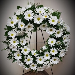 White daisy wreath on a black stand