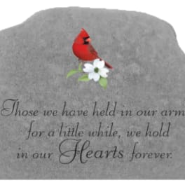 Gray memorial stone with a red cardinal and white flower engraving
