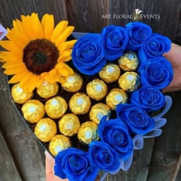Heart-shaped bouquet with a sunflower, blue roses, and gold-wrapped chocolates