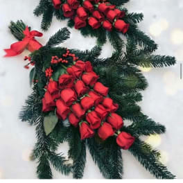 Red rose bouquets with evergreen branches and ribbon