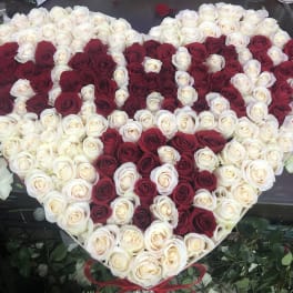 Heart-shaped arrangement of red and white roses
