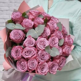 Large bouquet of pink roses with pale eucalyptus leaves