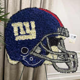 Football-shaped floral tribute in blue, white, gray, and red