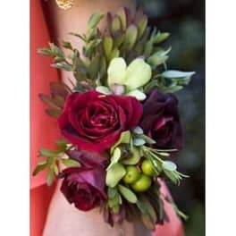 Small bouquet with deep red roses and pale green flowers