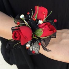 Red rose wrist corsage with black ribbon and bead accents