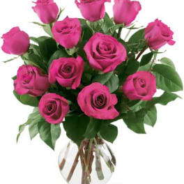 Pink roses arranged in a clear glass vase