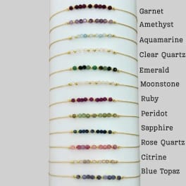 Beaded gemstone bracelets displayed on a white card with stone names.