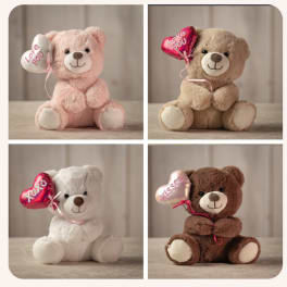 Four plush teddy bears holding heart balloons with love messages