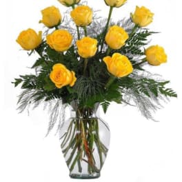 Yellow roses arranged in a clear glass vase