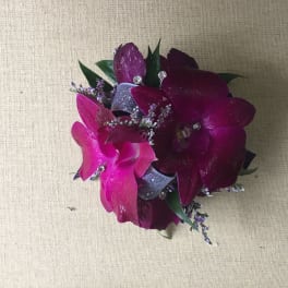 Small purple orchid corsage with ribbon and rhinestone accents