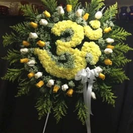 Large yellow and white floral standing wreath with ribbon