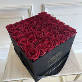 Square box filled with red roses