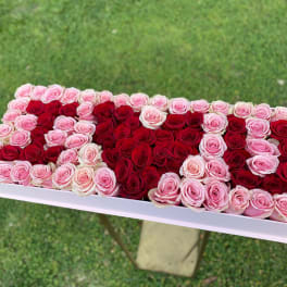 Rectangular box arrangement of red and pink roses