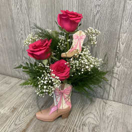 Pink roses arranged in a decorative boot with baby's breath