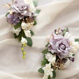 Two lavender and white floral corsages on sheer fabric