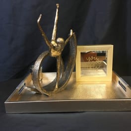 Gold decorative tray with abstract sculpture and framed mirror sign