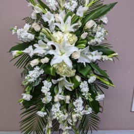 Tall white floral standing spray with lilies and roses