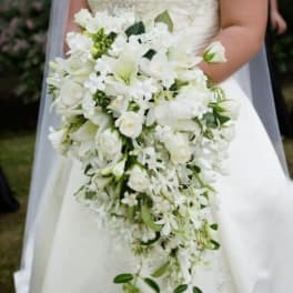 Bride holding a cascading white wedding bouquet