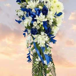 Blue and white floral standing spray with ribbon accents