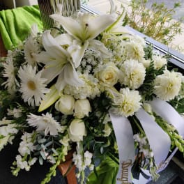 White floral spray with lilies, roses, and daisies