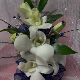 White orchid bouquet with blue ribbon and decorative beads