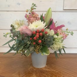Mixed bouquet in a gray vase with pink and white blooms