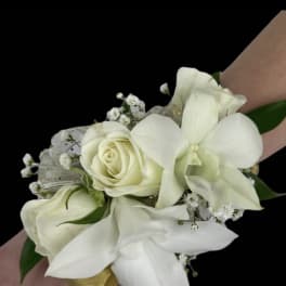 White rose and orchid wrist corsage with small filler flowers