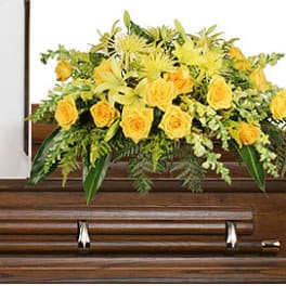 Yellow floral spray on a wooden casket