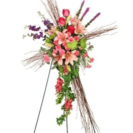 Tall floral standing spray with pink lilies, roses, and purple accents
